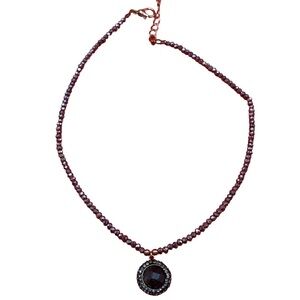Elegant Black Stone surrounded by crystals on a iridescent beaded chain.